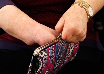 Another studio shot of Cindy's hands closing the purse.