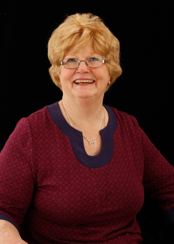 A studio shot of Cindy wearing the necklace but tucked inside her blouse.