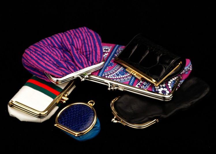 Another studio shot of the kiss-clasp handbags: six here, of varied shapes and colors.