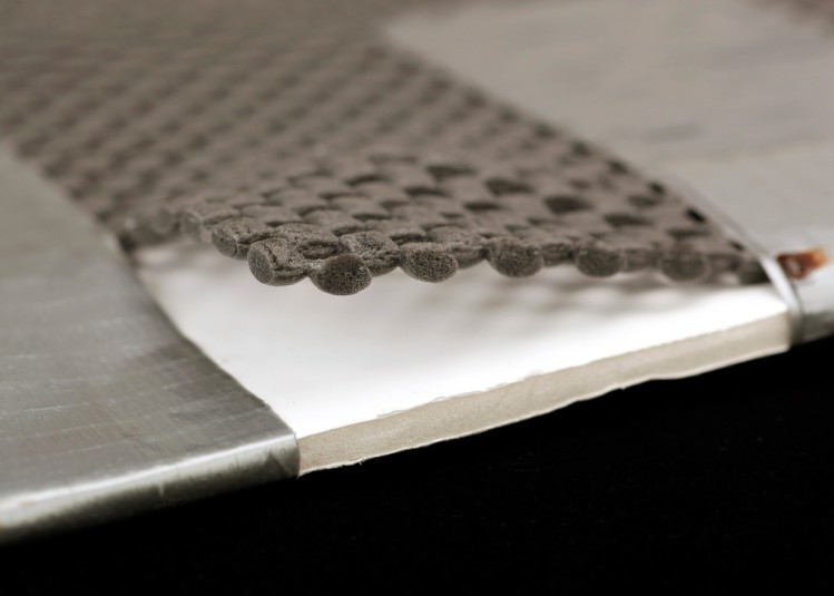 A close up shot of foam core layered with duct tape and grippy shelf liner: a combination of materials that provide a non-slip, lightweight surface for reading.