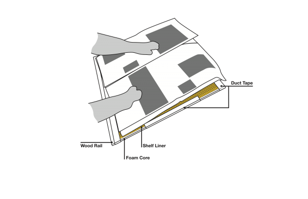 A technical drawing showing the layers and use of the newspaper board, with Cindy's hands able to manipulate the pages. Parts indicated are the wood rail at the bottom, the bottom layer of foam core, top layer of shelf liner, and duct taped sides and top edge.